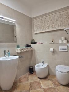 a bathroom with a white sink and a toilet at Andante con nobile in Dubrovnik +21 photos