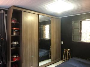 a room with a closet with a glass door at Casa próximo ao centro in Uruguaiana