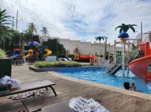 a swimming pool with a slide and a playground at Enjoy olimpia park resort in Olímpia