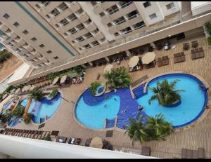 an overhead view of two swimming pools in a hotel at Enjoy olimpia park resort in Olímpia