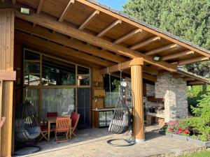 an outdoor patio with a wooden pergola at Villa - VALL DI VALL in Pirin Golf & Country Club in Razlog +26 photos