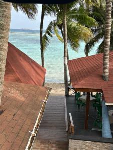 a view of the beach from a resort with a table and chairs at El Cayuco Restaurant Apart Hotel in Boca Chica