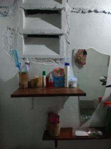 a bathroom shelf with toothbrushes and other items on it at chilean beer bar in Punta Cana