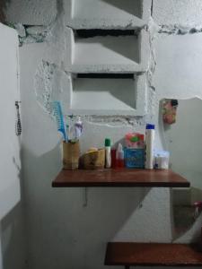 a bathroom shelf with toothbrushes and other items on it at chilean beer bar in Punta Cana