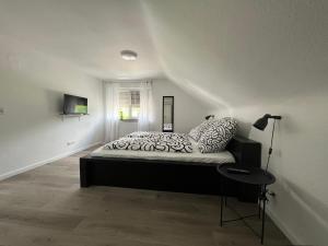 a bedroom with a bed in a white room at Ferienhaus am Schorren in Bad Schussenried