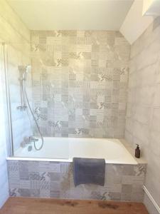 a bathroom with a shower and a bath tub at Le Balnéo Duplex avec balcon - Riva Bella Plage in Ouistreham +16 photos