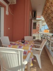 a table and chairs on the balcony of a house at Anna's apartment 2 in Preveza