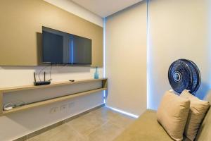 a living room with a tv and a couch at Marina do Cupe 302 in Porto De Galinhas