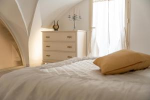 a bedroom with a bed and a dresser and a window at B&B Antica Stella in Ugento