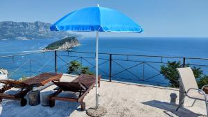 a patio with a table and an umbrella at High Hostel in Budva