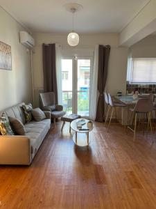 a living room with a couch and a table at Acropolis Sidewalk view in Athens