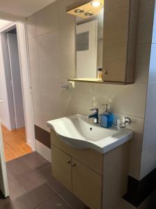 a bathroom with a sink and a mirror at Acropolis Sidewalk view in Athens +36 photos