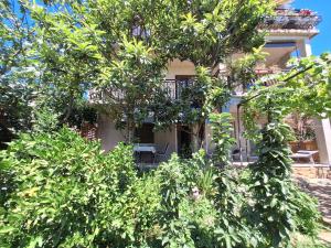 a house with trees in front of it at Apartment Harmonia in Dramalj