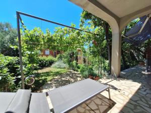 a patio with a bench and a garden at Apartment Harmonia in Dramalj +25 photos
