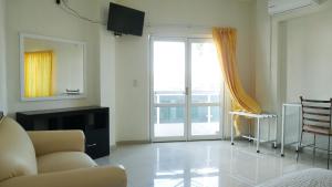 a living room with a couch and a sliding glass door at Hotel Insurgentes Express in Tepic