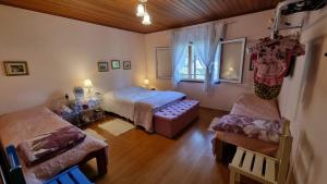 Ένα ή περισσότερα κρεβάτια σε δωμάτιο στο Casinha na serra