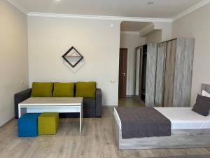a living room with two beds and a couch at Menua by Horizon Hotels, Yerevan in Yerevan