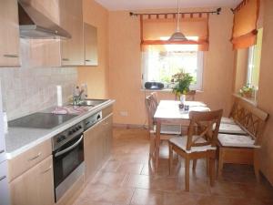 a kitchen with a sink and a table with chairs at Landurlaub in Schiebsdorf in Kasel-Golzig