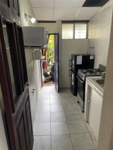 a kitchen with a sink and a stove at Hogar Parroquia in Guatemala
