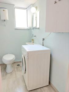 a white bathroom with a sink and a toilet at Φωτεινό δίκλινο δωμάτιο με θέα! in Athens
