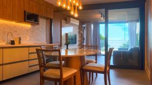 a kitchen with a table and chairs in a kitchen at Atlântico Collection in Rio de Janeiro