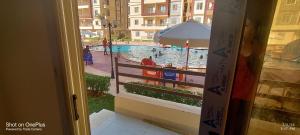 a view of a swimming pool from a window at الساحل الشمالى قرية جوليانا أمام قرية قناة السويس North Coast Juliana Resort Vip Chalet in Dawwār Muşādif Yūnus