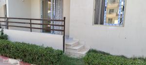 a set of stairs next to a building with a fence at الساحل الشمالى قرية جوليانا أمام قرية قناة السويس North Coast Juliana Resort Vip Chalet in Dawwār Muşādif Yūnus