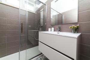 a bathroom with a white sink and a shower at Da Nonna Marzia in Carovigno +14 photos