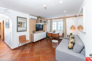 a living room with a couch and a table at Calas Beach Corralejo in Corralejo