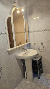a bathroom with a sink and a mirror at ApartamentoDJ in Suances