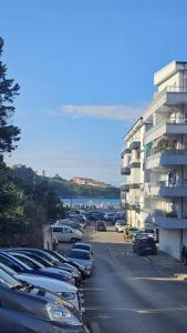 a parking lot with cars parked next to a building at ApartamentoDJ in Suances