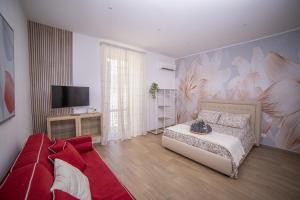 Una sala de estar con una cama y un televisor. en La portineria guest house, en Bari