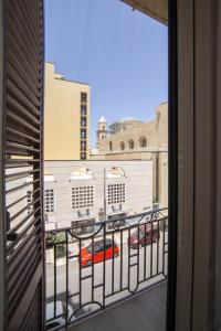 un balcón con vistas a un aparcamiento en La portineria guest house, en Bari
