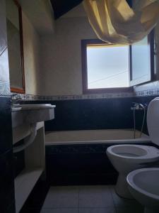 a bathroom with a sink and a toilet and a window at Casa Chalet in Ostende +15 photos