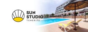 a swimming pool in front of a building at Sun Studio Tenerife in Arona