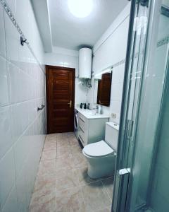 a bathroom with a toilet and a sink and a shower at Sun Studio Tenerife in Arona