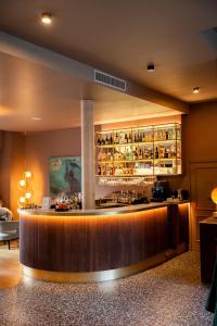 a bar in a hotel room with a counter at L'INVITATION AU VOYAGE - Hôtel & Spa in Honfleur