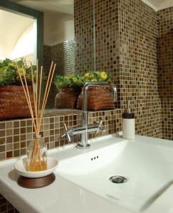 a bathroom sink with a vase on the counter at Hotel Terminal in Rome