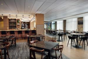 a restaurant with tables and chairs and a bar at Hyatt Place Nashville Downtown in Nashville