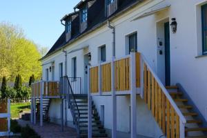a white building with stairs and a door at MP 2 Leuchtturm in Steinbeck