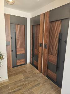 a hallway with wooden doors in a house at La Vida Apartments in Babalonija