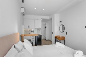 a bedroom with a bed and a small kitchen at Ecstasea Corfu in Ipsos
