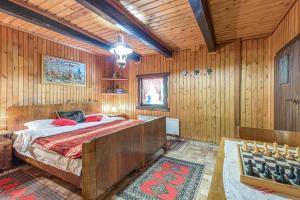 a bedroom with a bed in a wooden room at Chalet Birchwood With Whirlpool and Sauna - Happy Rentals in Hum Breznički