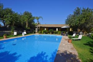 a swimming pool in the yard of a house at Villa Torres - Happy Rentals in Scicli