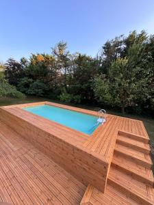 a wooden deck with a swimming pool on top of it at Villa Visocchi Bed and Breakfast in Atina