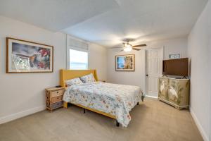 a bedroom with a bed and a flat screen tv at Private Dock Waterfront Inverness Abode! in Inverness