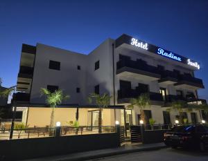 a large white building with a sign on it at RADINA FAMILY in Kallithea Halkidikis
