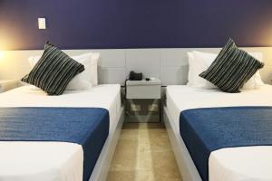 Postel nebo postele na pokoji v ubytování Hotel Lleras 10