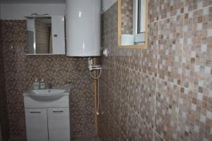 a bathroom with a sink and a mirror at Casa La Bunica in Orşova +14 photos