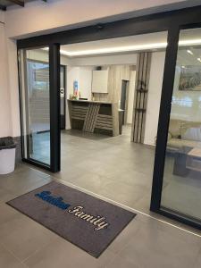 a sliding glass door with a entry mat in a room at RADINA FAMILY in Kallithea Halkidikis